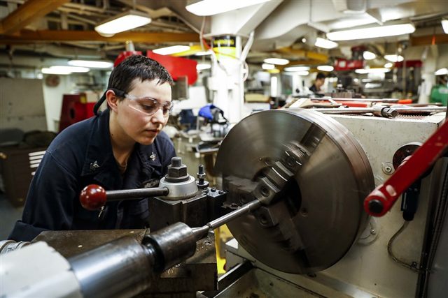 Machinist operating a lathe